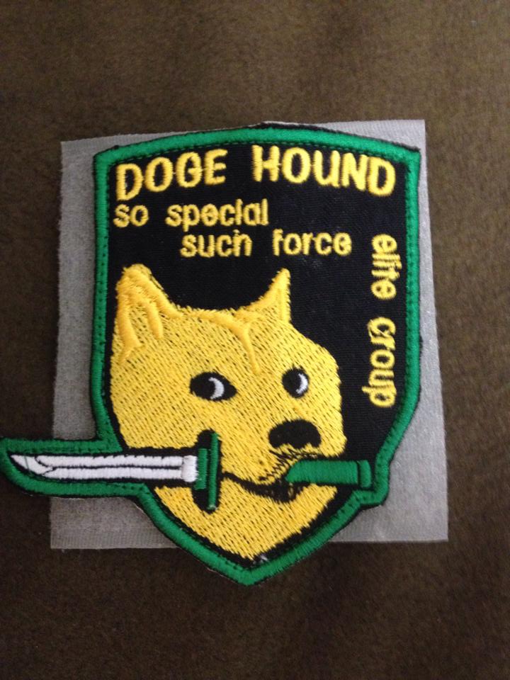 ambiguous_gender badge black_nose cloth dagger feral fur grey_background humor joke looking_at_viewer melee_weapon mouth_hold real simple_background solo special_forces text weapon yellow_body yellow_fur unknown_artist dogelore konami metal_gear doge canid canine canis domestic_dog mammal shiba_inu spitz 2016 3:4 crossover english_text meme