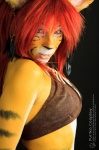 blue_eyes bodypaint clothed clothing cosplay ear_piercing feathers female hair leather painted_markings piercing real red_hair skimpy solo stripes tribal tribal_clothing yurikocosplay felid humanoid mammal pantherine tiger