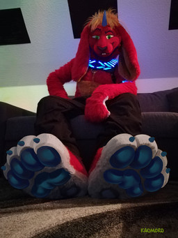 4_toes anthro barefoot black_clothing blonde_hair blue_claws blue_horn blue_pawpads bottomwear buckteeth claws clothed clothing costume feet foot_fetish foot_focus fur furniture fursuit green_eyes hair hindpaw horn long_ears looking_at_viewer male pants pawpads paws red_body red_fur sitting smile sofa soles solo teeth toe_claws toes white_body dream_and_nightmare kaomoroart cirez hybrid lagomorph leporid mammal rabbit 3:4 draw_over hi_res photography_(artwork)