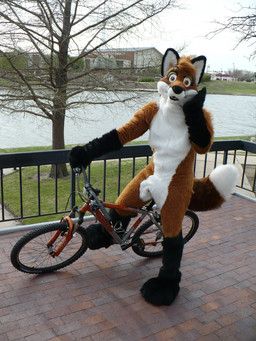 anthro bicycle church clothing costume cycling fence fursuit male mountain_bike outside plant real sky snout solo tree vehicle water whiskers wood yellow_eyes unknown_artist jimdalefox canid canine fox mammal 3:4 grandfathered_content hi_res photography_(artwork)