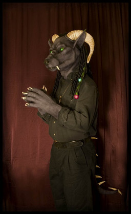 anthro belt bottomwear clothed clothing costume dreadlocks fangs fully_clothed fursuit horn male pants real shirt solo spikes teeth topwear qarrezel godzuki gargoyle grandfathered_content