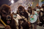 ambiguous_gender clothing costume crowd drum fursuit group holidays musical_instrument nightmare_fuel parade percussion_instrument real rio_de_janeiro unknown_artist brazilian_carnival carnival_(holiday) canid canine canis human mammal wolf 2011