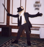 anthro clothed clothing costume furgonomics fursuit gloves handwear hat headgear headwear hotel male melee_weapon necktie pose real solo speaker suit sword vintage weapon unknown_artist anthrocon canid canine fox mammal 1999 grandfathered_content photography_(artwork)