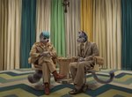anthro cigarette_holder clock clothing curtains duo eyewear footwear furniture glasses hair interview jacket leather leather_clothing leather_jacket leather_topwear leg_on_thigh male shoes sitting suit table topwear watch geewolf the_french_dispatch domestic_cat felid feline felis mammal procyonid raccoon 2023 digital_media_(artwork)