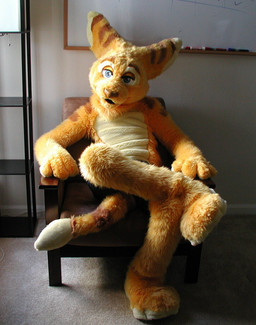 anthro biped clothing costume fursuit looking_at_viewer male real sitting solo tail unknown_artist ratchet_and_clank sony_corporation sony_interactive_entertainment ratchet_(ratchet_and_clank) lombax mammal grandfathered_content hi_res source_request
