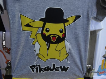 ambiguous_gender clothing feral fur grey_clothing grey_shirt grey_t-shirt grey_topwear photo print_clothing print_shirt print_t-shirt print_topwear real shirt solo t-shirt tail text text_on_clothing text_on_shirt text_on_topwear topwear yellow_body yellow_fur unknown_artist nintendo pokemon generation_1_pokemon mammal pikachu pokemon_(species) rodent english_text grandfathered_content source_request
