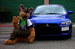 anthro brown_eyes california car clothing costume fursuit german kerchief male pose real solo vehicle unknown_artist mitsubishi mitsubishi_lancer doryuu canid canine canis domestic_dog mammal grandfathered_content photography_(artwork)