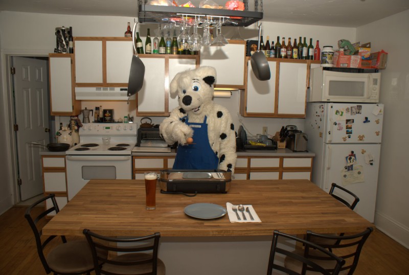 alcohol anthro appliance apron beer beverage biped black_body black_fur black_spots blue_apron blue_clothing blue_eyes bottle building butter_knife cabinet cardboard ceiling chair clothed clothing cocktail_glass container cooking_pot cookware costume countertop cup cutlery dark_spots detailed_background door doorknob drinking_glass floor food fork fridge frying_pan fur furniture fursuit glass glass_bottle glass_container glass_cup house inside internal_wall kitchen kitchen_appliance kitchen_cabinet kitchen_knife kitchen_stove kitchen_utensils knife machine magnet male markings metal_container metal_cooking_pot microwave_oven open_door oven plaster_(material) plaster_ceiling plate real solo spoon spots spotted_body spotted_fur stove table toaster tools wall_(structure) wall_cabinet white_body white_ceiling white_fur white_wall wine_glass wood wood_floor wood_furniture wood_table unknown_artist pup1k canid canine canis dalmatian domestic_dog mammal grandfathered_content photography_(artwork)